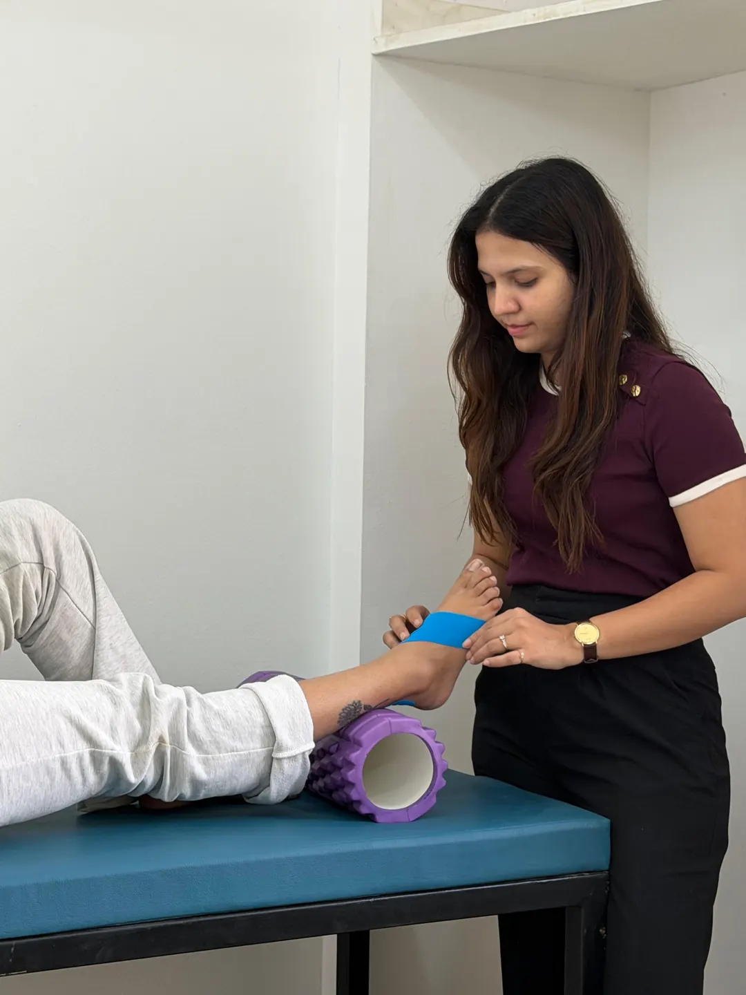 Kinesiology taping on a foam roller setup