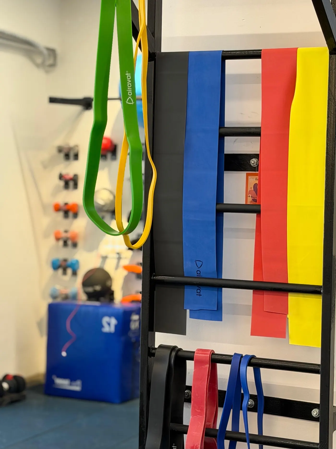 Wall of resistance bands and rehab equipment at All Things Physio